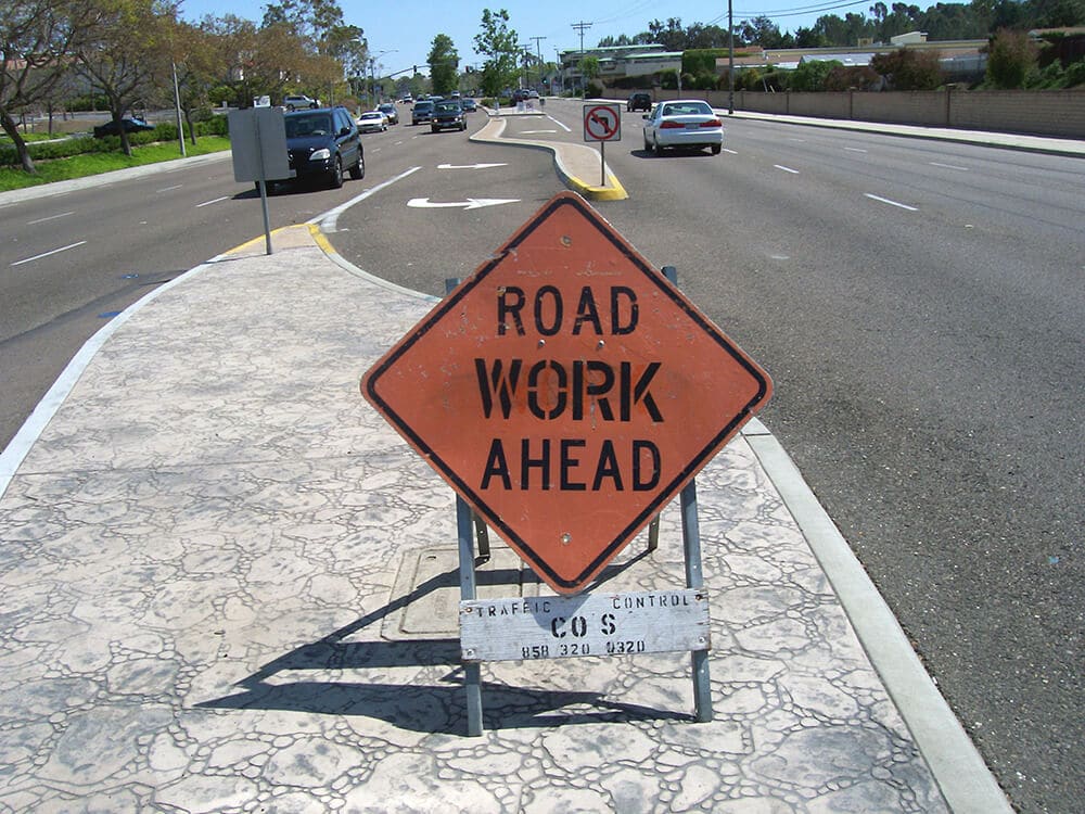 Road work ahead sign in road