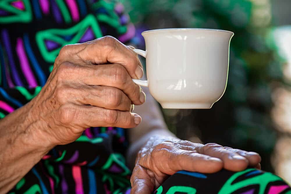Older person holding teacup